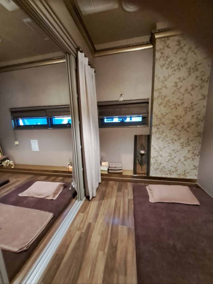 Two treatment rooms joined by a sliding partition, opened up for a group