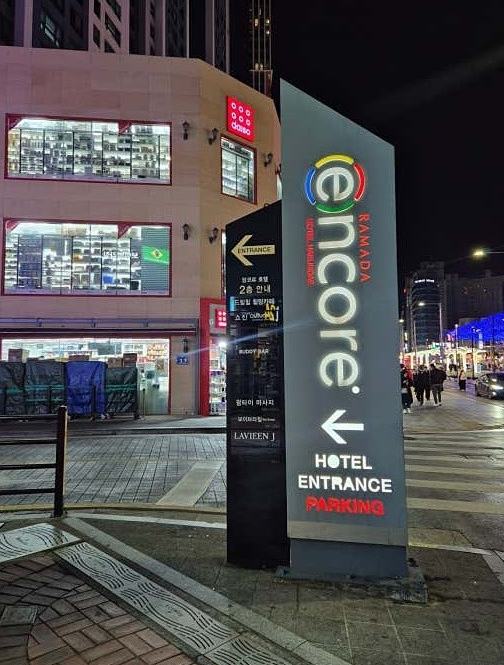 Illuminated Ramada Encore hotel entrance pylon listing the 2nd floor tenants
