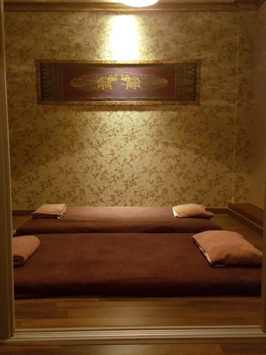 Treatment room seen through open doors, two mats made up with towels and pillows